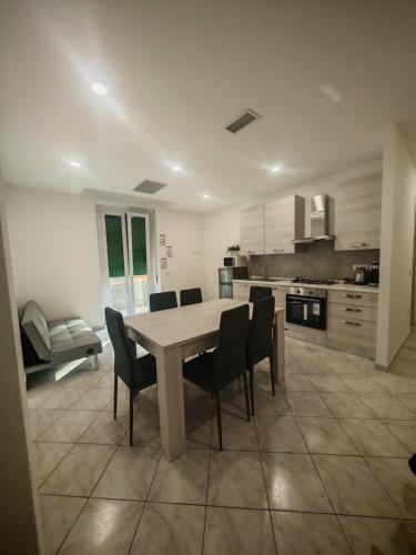 a large kitchen with a table and chairs at Pachira house in Alghero