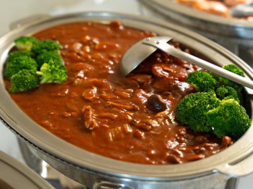 a bowl of chili with broccoli and a spoon in it at APA Hotel Karuizawa Ekimae Karuizawaso in Karuizawa
