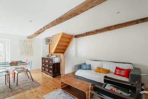 a living room with a couch and a table at La petite Hautière in Plouër-sur-Rance
