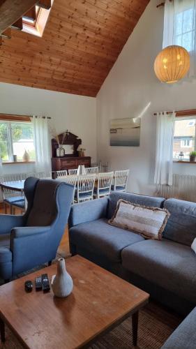 a living room with two blue couches and a table at Saltögården in Strömstad