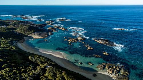 an aerial view of a rocky island in the ocean at Karrak Reach Forest Retreat in Denmark