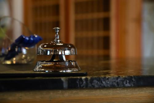 a silver bell sitting on top of a table at Hotel zur Isar in Plattling