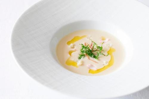 a white bowl filled with food on a white plate at GrandEmpireHotel in Onojo