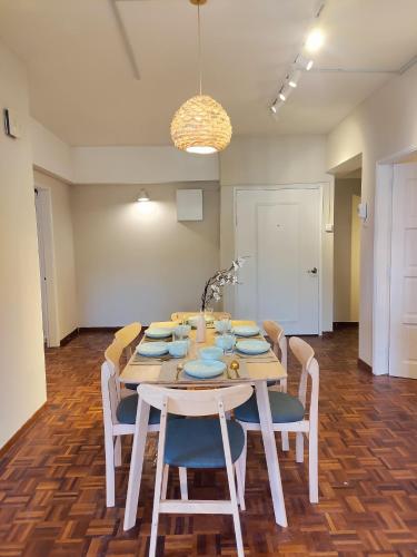 a dining room with a table with chairs and a light at Star Regency by Plush in Brinchang