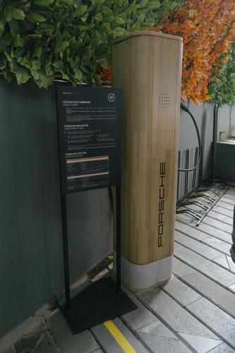 a sign next to a large wooden box on a sidewalk at Awann Sewu Boutique Hotel and Suite Semarang in Semarang