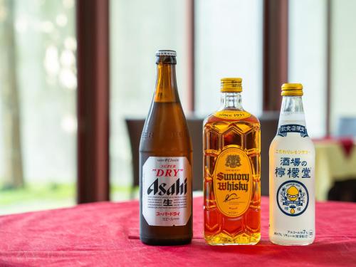 two bottles of beer sitting on a red table at APA Hotel Karuizawa Ekimae Karuizawaso in Karuizawa