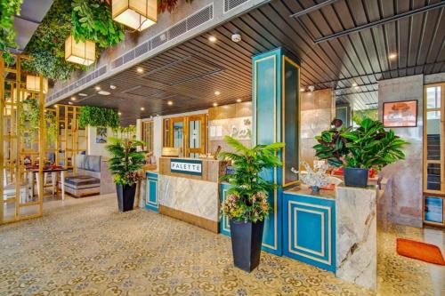a lobby with potted plants in a store at The Pikus Paradise in Digha