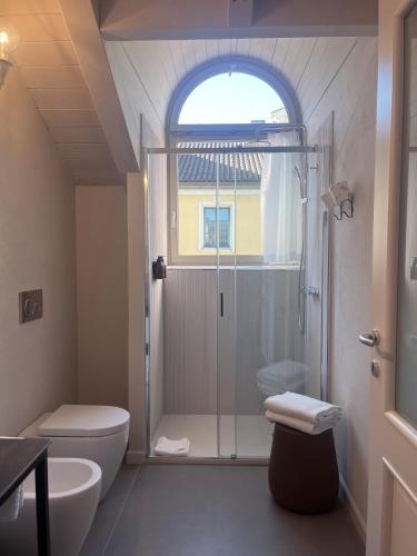 a bathroom with a shower and a toilet at Residenza Dell' Opera in Turin