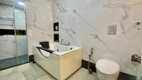 a white bathroom with a sink and a toilet at Willo Stays On the beach Sea view Ocean Hues holiday home in Kannur