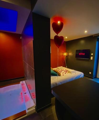 a room with a bed with a heart balloon on the wall at La Maison D'Albâtre in Couternon