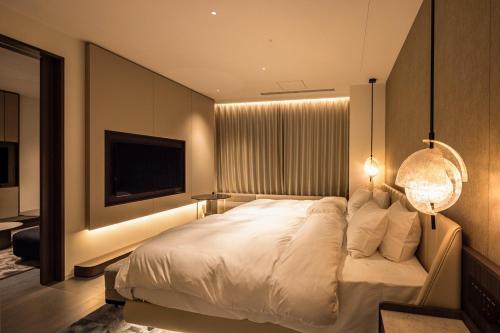 Postel nebo postele na pokoji v ubytování ATAGO HOTEL