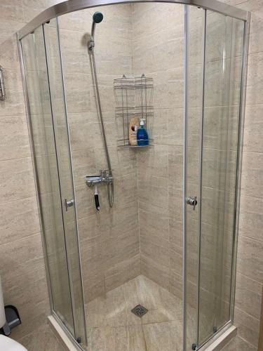 a shower with a glass shower stall in a bathroom at Sunny holidays in Byala
