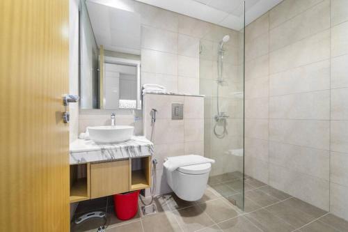 a bathroom with a toilet and a sink and a shower at FIRST CLASS Studio Luxe Living in Dubai