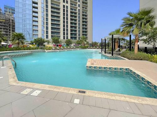 a large swimming pool in the middle of a city at FIRST CLASS Studio Luxe Living in Dubai
