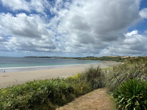 a view of a beach with people walking on the sand at Wisteria Cottage in Truro