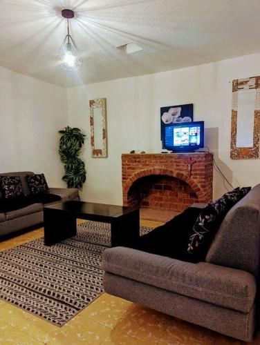a living room with a couch and a fireplace at Entire Casa Madrigal in the heart of Guanajuato in Guanajuato