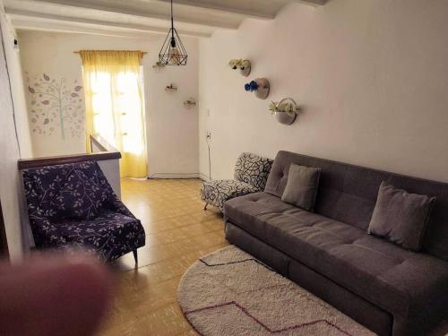 a living room with a couch and a chair at Entire Casa Madrigal in the heart of Guanajuato in Guanajuato