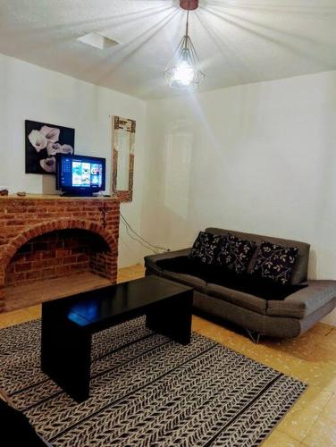 a living room with a couch and a fireplace at Entire Casa Madrigal in the heart of Guanajuato in Guanajuato