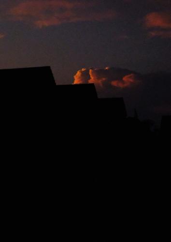 a silhouette of a building with a sunset in the background at Waste Land Homestay & Resort Chiangmai in San Pa Tong