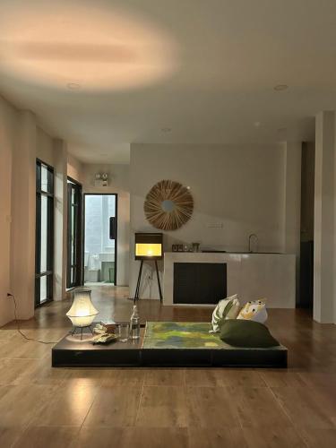 a living room with a couch and a table at Waste Land Homestay & Resort Chiangmai in San Pa Tong