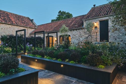 a garden in front of a house with lights at The Piggery in Glastonbury