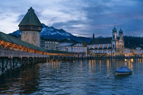 a bridge over a body of water in front of buildings at NH 7 Interlaken-Luzern I Lake I Mountain I connect in Sachseln