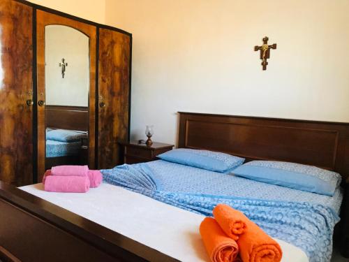 a bedroom with a bed with towels on it at CASA VACANZA PALMENTO BELLA in Santa Maria Del Focallo