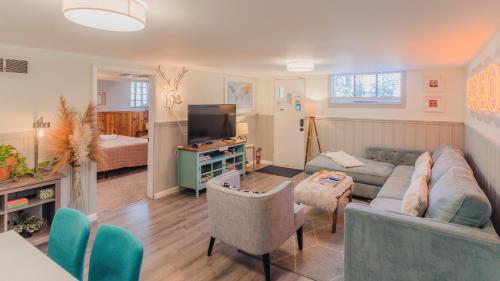 a living room with a couch and a tv at Sloans Lake Walk to eateries bars Free parking in Denver