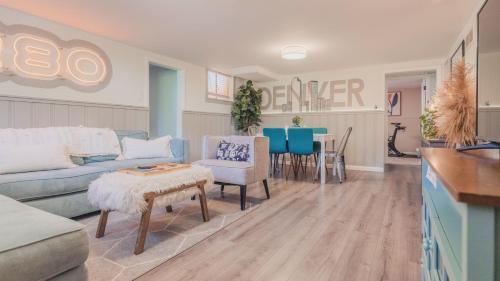 a living room with a couch and a table at Sloans Lake Walk to eateries bars Free parking in Denver