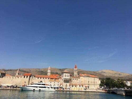 a group of boats in the water next to a city at Vila Liza in Trogir