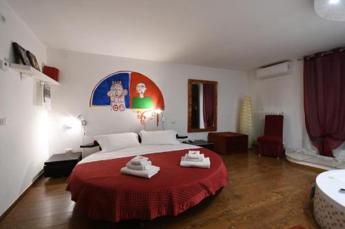 a bedroom with a bed with towels on a red blanket at La Dimora dell' Architetto in Gravina in Puglia