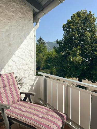 a chair sitting on the porch of a house at Ferienwohnung Flynn in Sonthofen