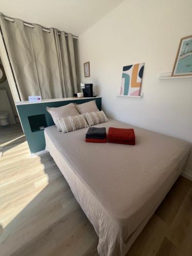 a bedroom with a large bed with a red blanket at La Casa del Roc in Sainte-Colombe