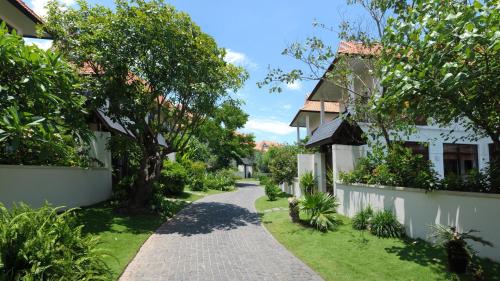 a path through the garden of a house at Furama Villas Danang in Danang