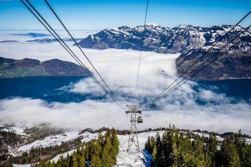 a gondola ride over a snow covered mountain at NH 2 Interlaken-Luzern Lake I Mountain I unique I connect in Sachseln