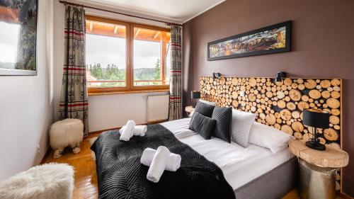 a bedroom with a bed with white crosses on it at Apartament Krzeptowki Exclusive in Zakopane