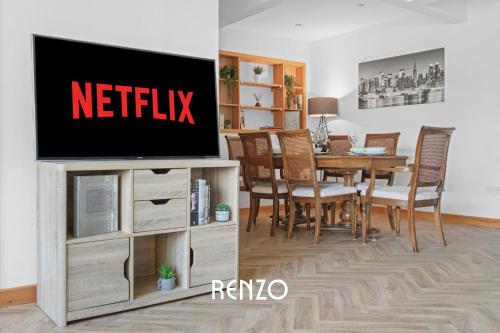 a living room with a television on a entertainment center at Vibrant 2-bed Home in Nottingham by Renzo, Free Driveway Parking, Sleeps 6! in Nottingham