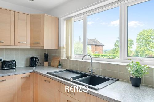 a kitchen with a sink and a window at Vibrant 2-bed Home in Nottingham by Renzo, Free Driveway Parking, Sleeps 6! in Nottingham