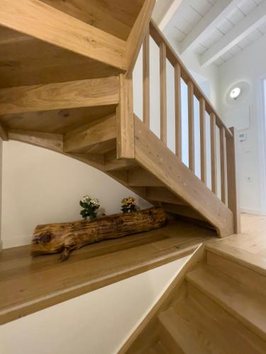 a wooden staircase in a home with wooden floors at Bigtrel Athens in Athens