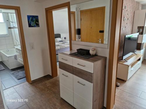 a kitchen with a counter with a sink and a mirror at Apartment Bochum in Bochum