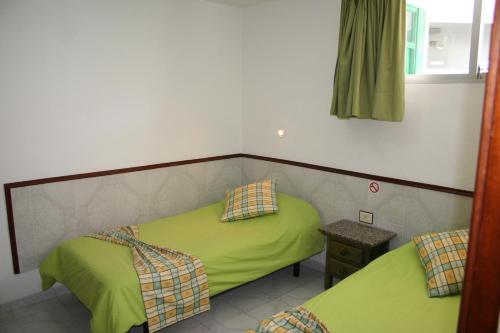 A bed or beds in a room at Apartamentos Maba Playa
