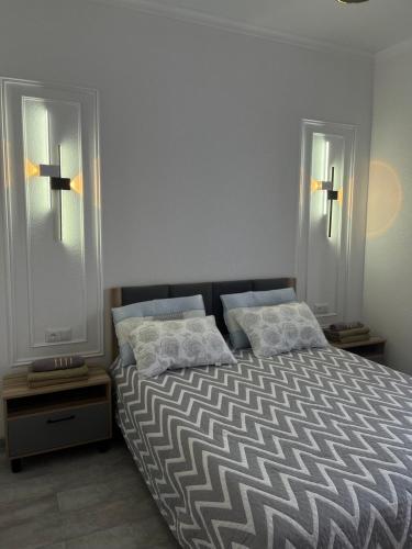 a bedroom with a bed with two pillows on it at Коттедж в центре отдыха Париж 2 in Chok-Tal