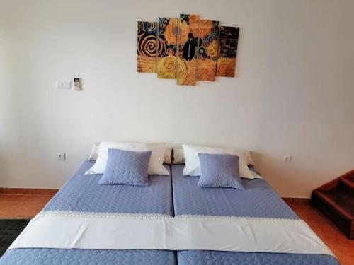 a bed with blue pillows in a room at Studio apartment Milna, Hvar Buratovic in Hvar