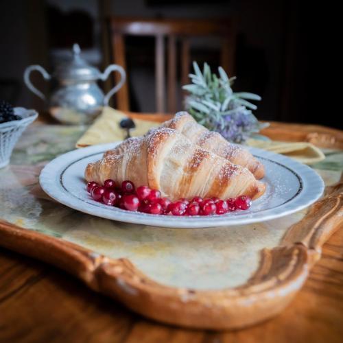 a white plate with a pastry on a table at Villa Clodia Relais in Manziana