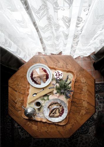 a wooden table with a tray of food on it at Villa Clodia Relais in Manziana