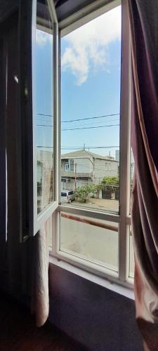 an open window with a view of a building at Guesthouse Qeti in Batumi
