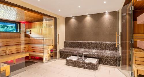 a bathroom with a shower with two sinks in it at PLAZA Premium Timmendorfer Strand in Timmendorfer Strand