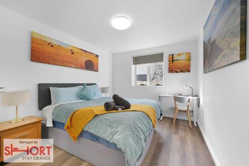 a bedroom with a bed with a teddy bear on it at Conservatorium Villa 1 in Orange