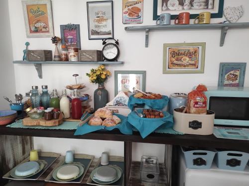 a shelf with plates and food on top of it at Caledonia B&B in Mercato San Severino
