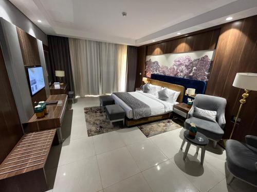 a bedroom with a bed and a couch and a tv at Tolip Resort El Galala Heights in Ain Sokhna